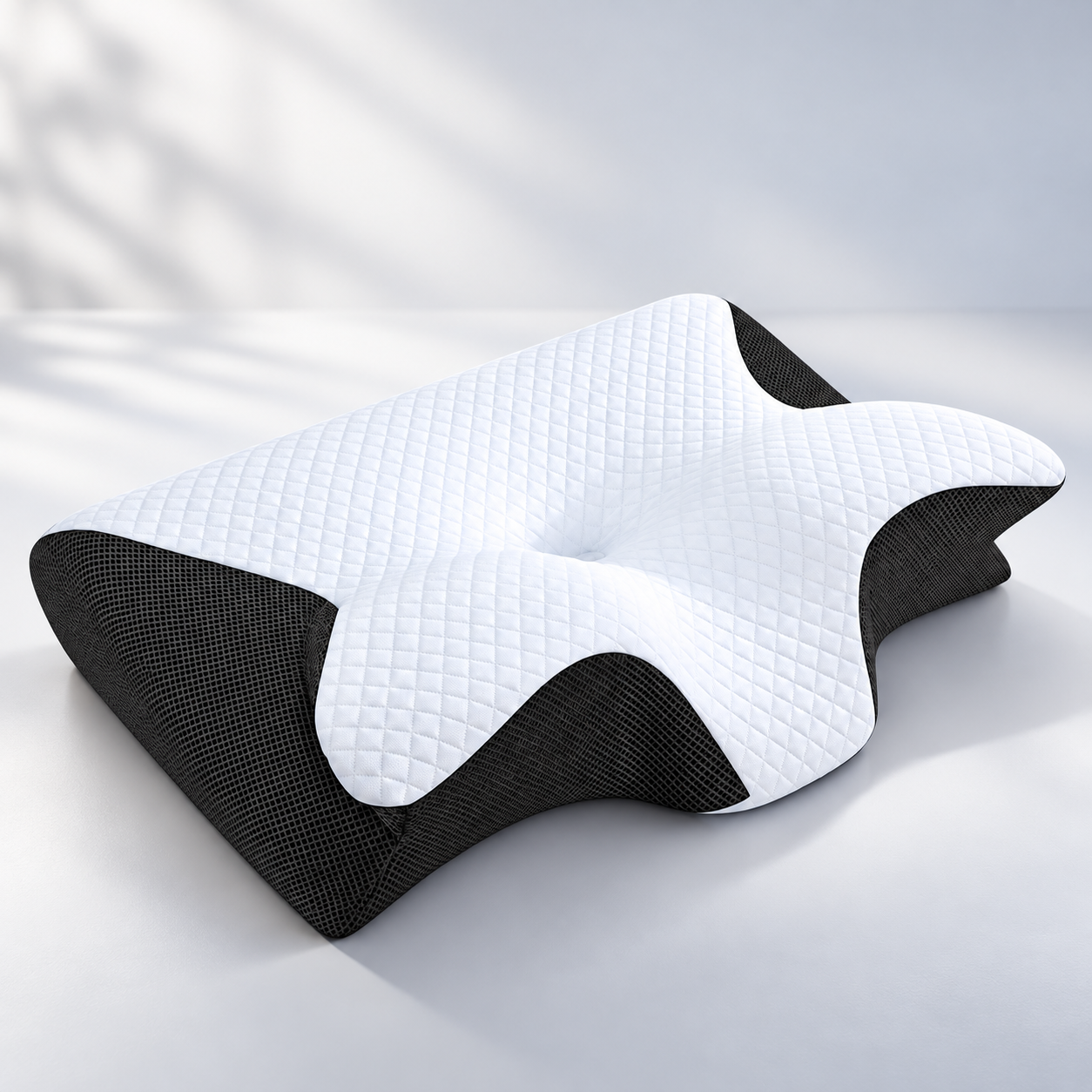 Angled view of the ERGONAX contoured memory foam pillow showing the sculpted center cradle and black side panels.